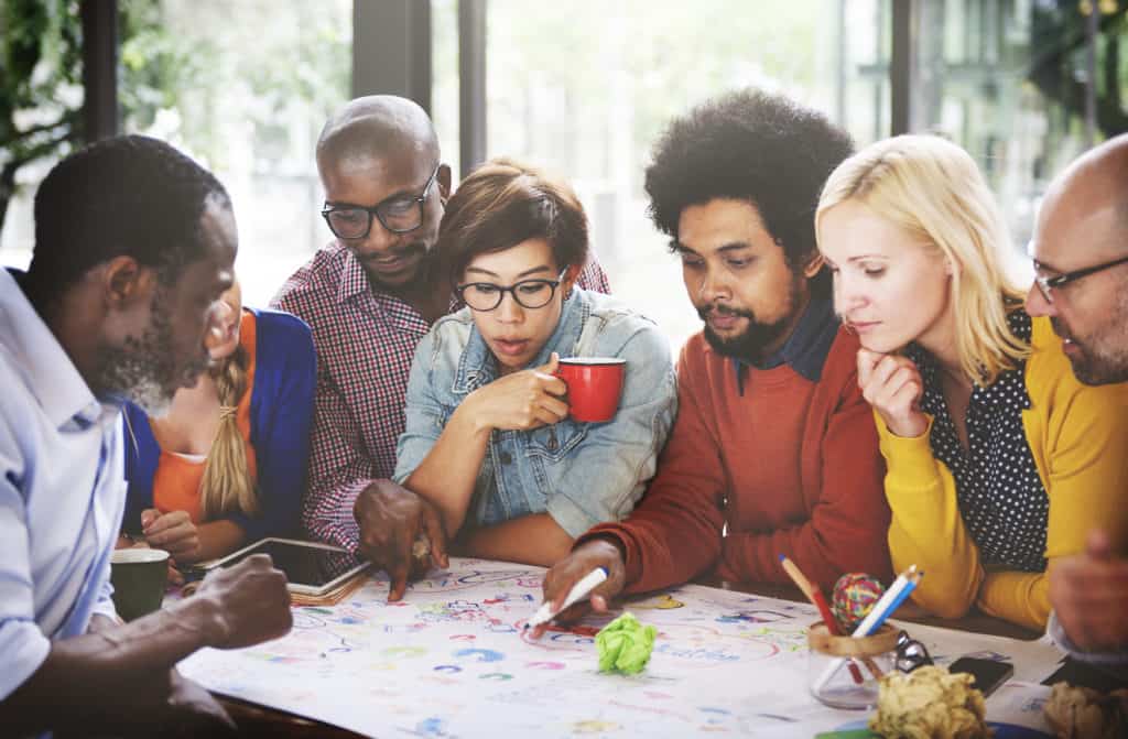 People working collaboratively around a desk