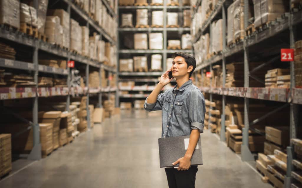 worker standing in a warehouse aisle