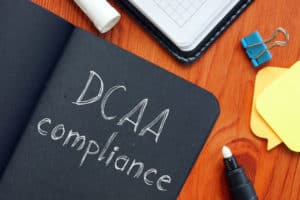 DCAA compliance written on a notebook